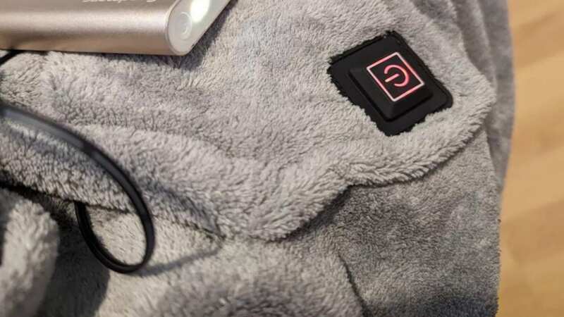 The heated hoodie blanket works with a powerbank that costs pennies to charge (Image: Emma Gill/MEN)