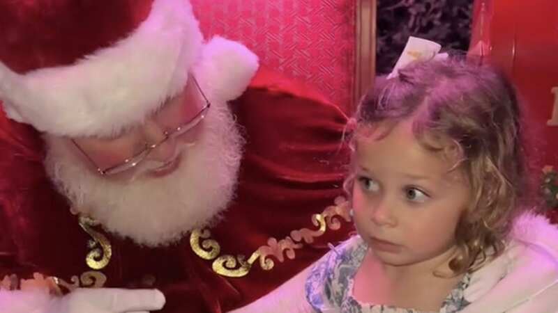 Adley Martin, 3, says no to sitting on Santa’s lap (Image: Katie Love / SWNS)