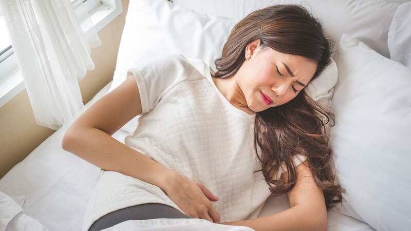 A woman struggles with a stomach bug (file image) (Image: Shared Content Unit)