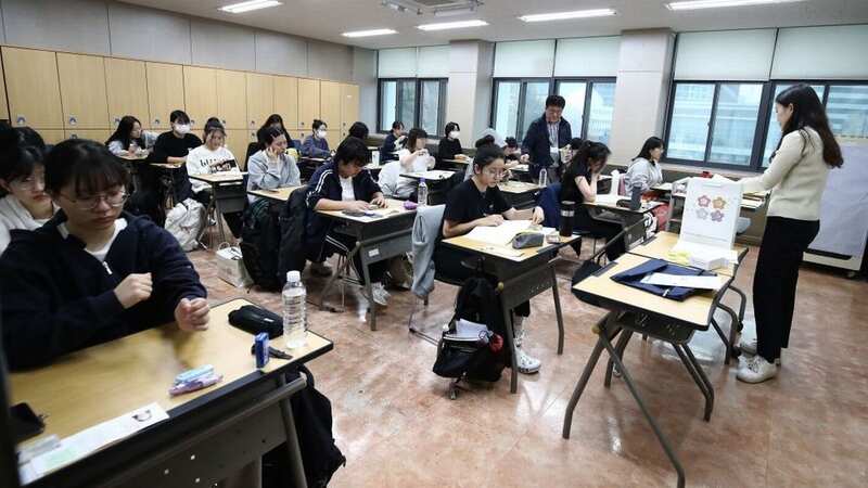 South Korean students wait to take the annual College Scholastic Ability Test at a Seoul school (Image: POOL/AFP via Getty Images)