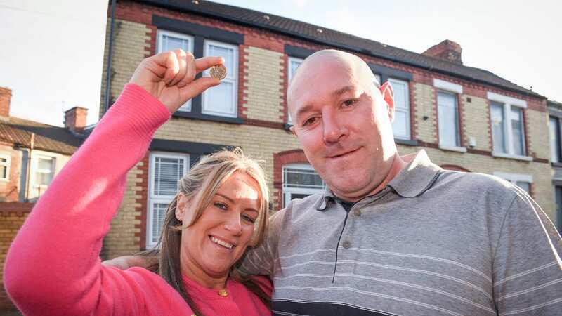 Debbie and Ste Hodge and their home on Garrick Street in Liverpool which they bought for just £1. (Image: Andy Kelvin/Triangle News)