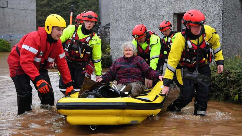 An elderly resident is evacuated by a Coastguard team from a flooded street in Brechin, northeast Scotland, on October 20, 2023 (Image: AFP via Getty Images)