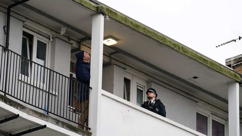 Police officers on the third floor balcony of Spenlow House in Jamaica Road, Bermondsey, south east London (Image: PA)