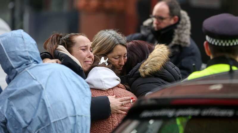 Distraught onlookers comfort each other at the scene of a fatal stabbing on Cranwood Street in East London (Image: Dinendra Haria/LNP)