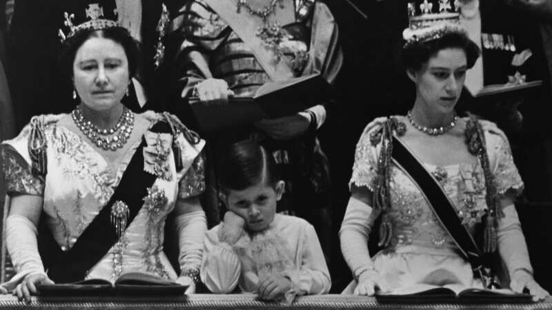 The black-and-white photo shows the-then Prince Charles in between his aunt, Princess Margaret, and grandmother, Elizabeth the Queen Mother (Image: Corbis via Getty Images)