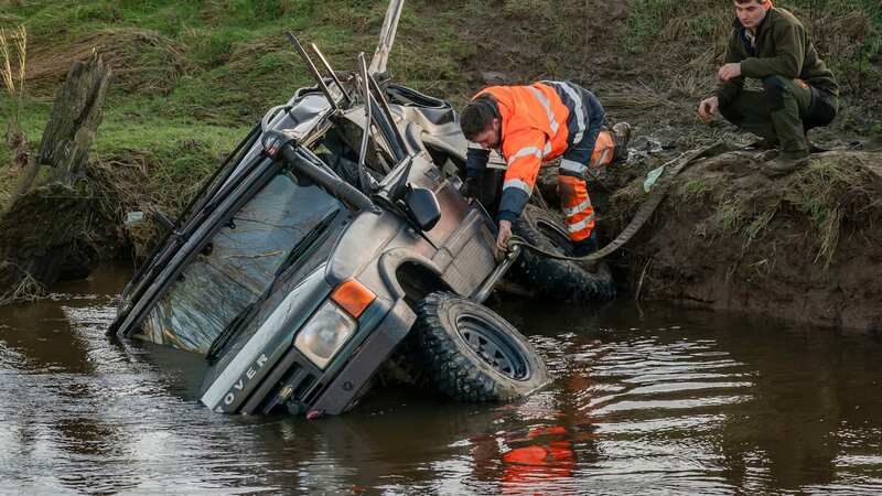 The Land Rover was pulled from the water by emergency services after three men tragically died (Image: PA)