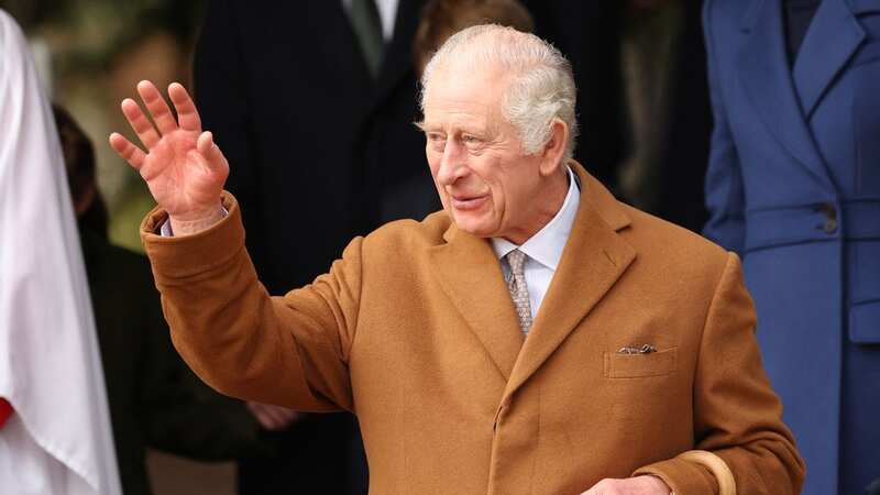 King Charles III waves to well-wishers after attending the Royal Family