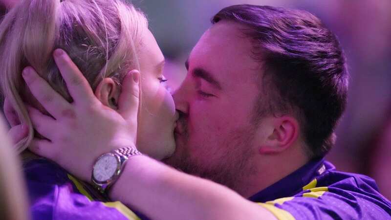 Luke Littler shares a kiss with his girlfriend (Image: AP)