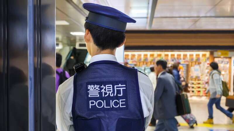 A police officer is pictured at a train station in Japan (file image) (Image: Getty Images)