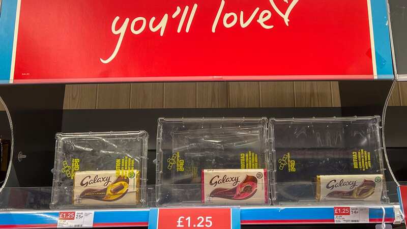 Galaxy Chocolate bars priced at £1.25 in plastic security boxes at a Co-op store (Image: SWNS)