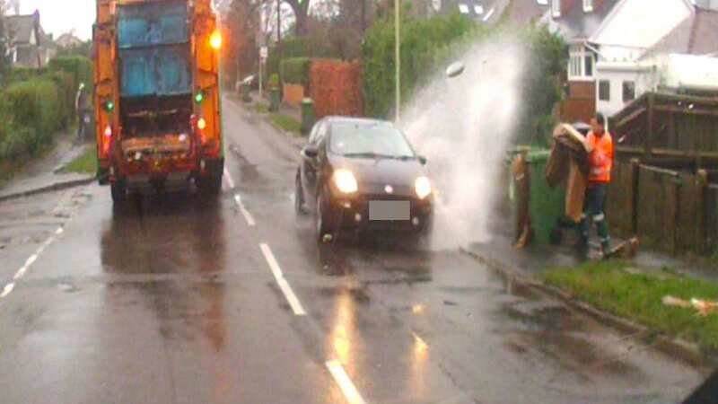 Motorist caught on dashcam speeding through huge puddle and soaking binman