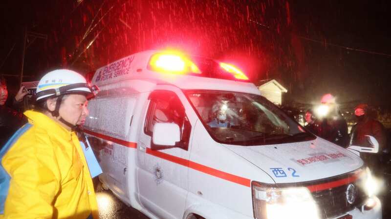 The woman reportedly leaving in an ambulance after being rescued (Image: The Asahi Shimbun via Getty Imag)