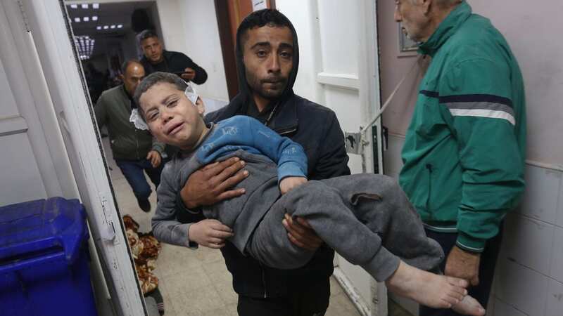 A Palestinian man carries an injured boy as a result of Israeli strikes in Gaza (Image: Anadolu via Getty Images)