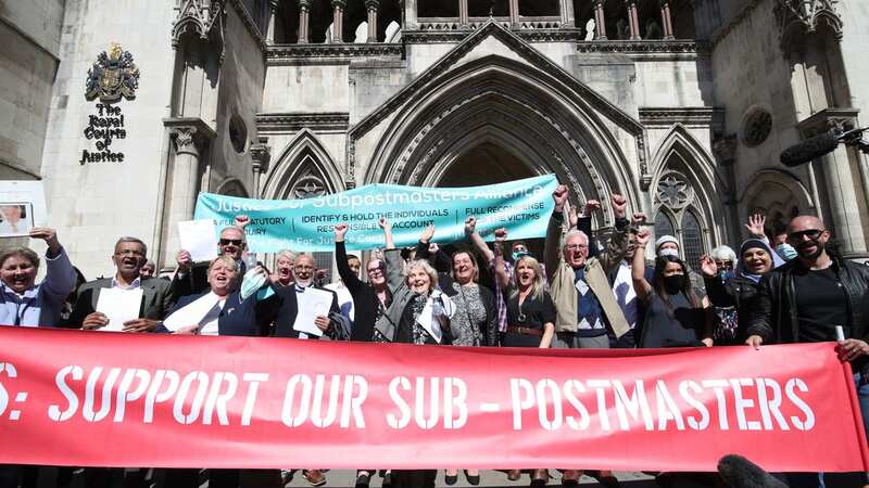 Former post office workers celebrate outside the Royal Courts of Justice in 2021 (Image: PA)