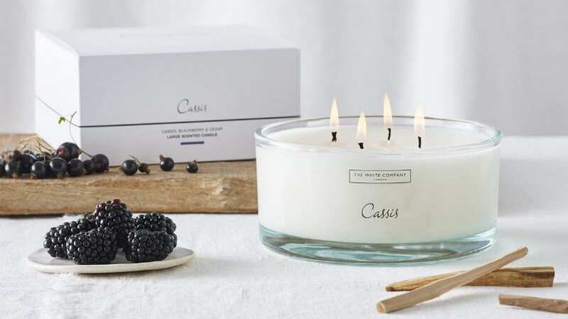 The White Company Cassis candle has wintery notes of cedar, blackcurrants and blackberries (Image: The White Company)