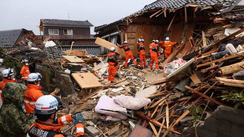 Firefighters search for victims at a collapsed house after a previous quake (Image: AP)