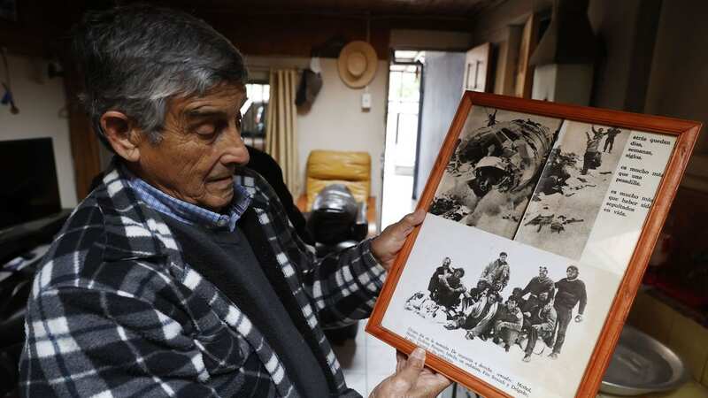 Former Chilean Air Force nurse Jose Bravo, who treated the survivors, examines photos of the Andes passengers five decades later (Image: Elvis Gonzalez/EPA-EFE/REX/Shutterstock)