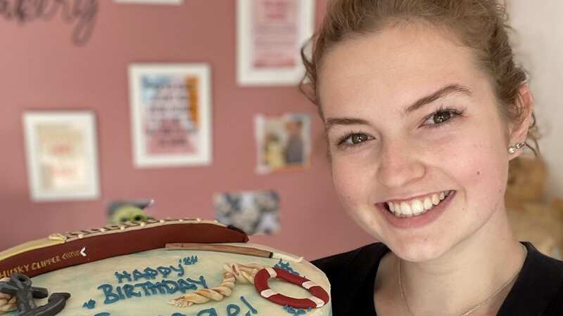 Holly Tait, 22, with the cake she made for George Clooney