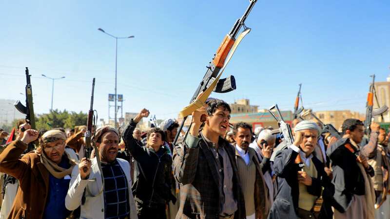 Houthi fighters brandishing their weapons (Image: AFP via Getty Images)