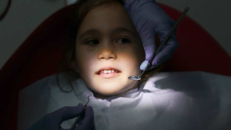 Young girl receives dental treatment (Image: Getty Images)