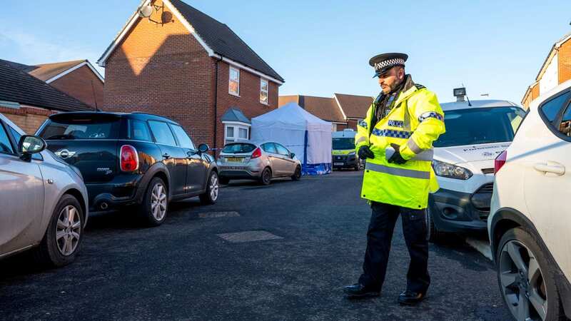 An officer at the scene of the tragedy along the residential road in Costessey (Image: James Linsell-Clark / SWNS)