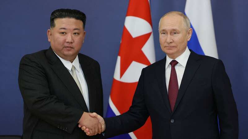 Russian President Vladimir Putin shakes hands with North Korean leader Kim Jong Un (Image: POOL/AFP via Getty Images)