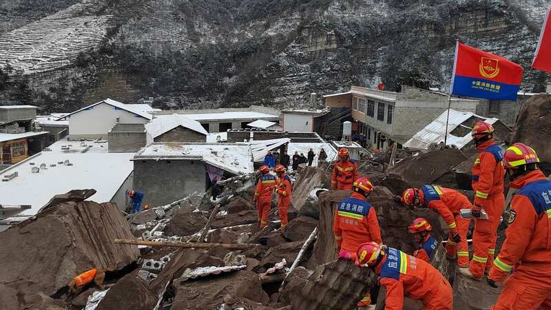 Rescuers work at the site of a landslide in Liangshui Village, Tangfang Town in the city of Zhaotong, southwest China