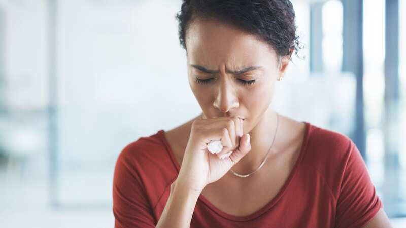 A woman struggles with a chesty cough (file image) (Image: Getty Images)