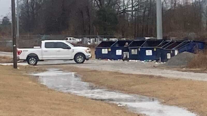 The baby was found on a car seat behind this dumpster near Cayce, Mississippi (Image: WREG)
