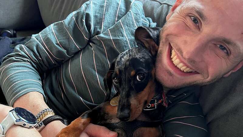 Dan Godley, 30, pictured with his sausage dog Lucy, is now cancer free after having a rare surgery (Image: Dan Godley / SWNS)