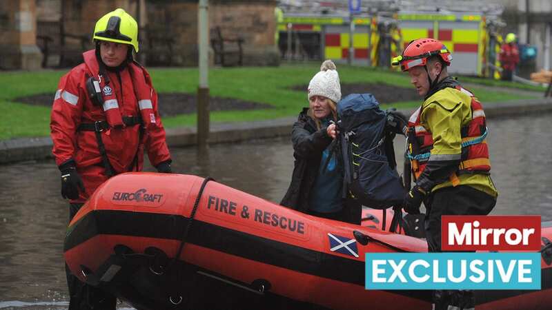 Firefighters help as the River Tay bursts (Image: Perthshire Advertiser)