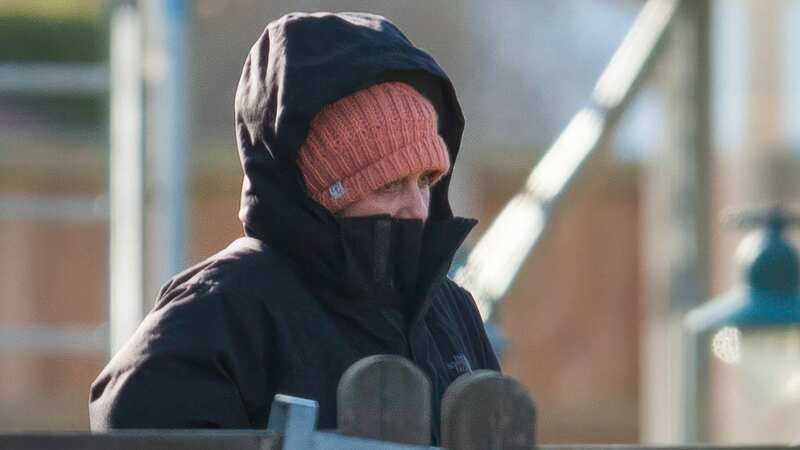 Hannah Ingram-Moore donned an orange hat and a black North Face jacket as she watched her spa being torn down today (Image: Bav Media)