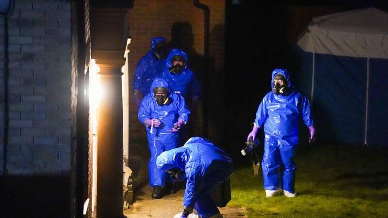 Blue-suited investigators with gas masks probed a house tonight (Image: TERRY BLACKBURN / BACKGRID)