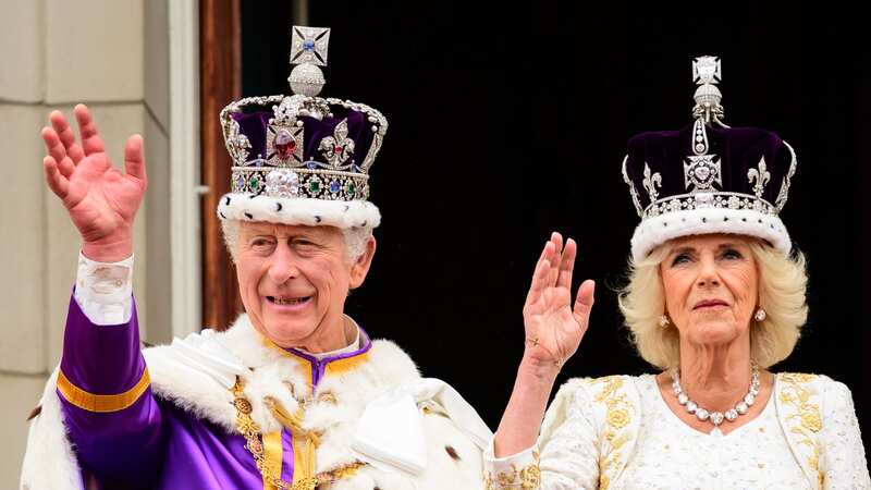 King Charles and Queen Camilla wave to crowds from the balcony of Buckingham Palace in May 2023 (Image: Getty Images)