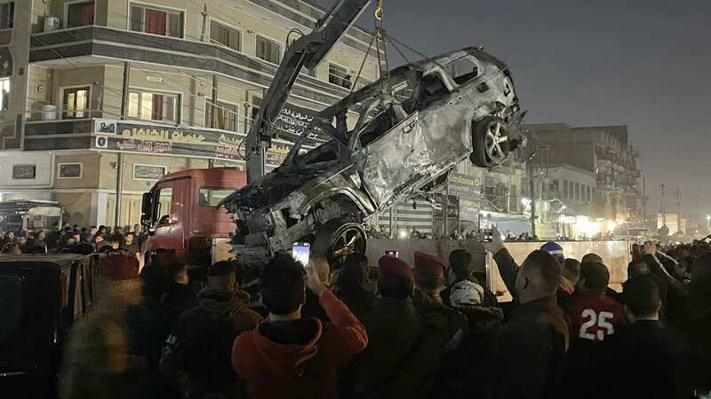 A crane lifts the wrecked car of senior commander Abu Baqir al-Saadi (Image: Anadolu via Getty Images)