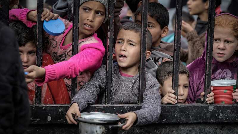 Children wait in line to receive food from volunteers in Rafah (Image: Anadolu via Getty Images)