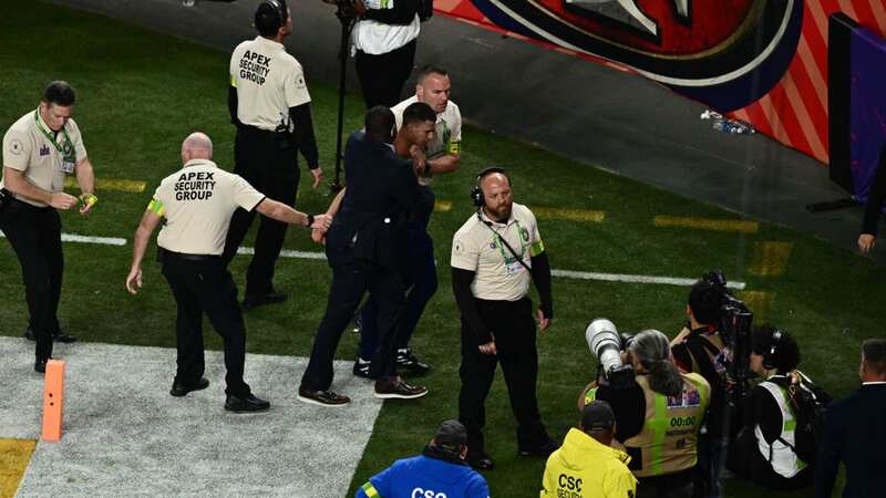 Both fans were quickly tackled by security and detained (Image: PATRICK T. FALLON/AFP via Getty Images)