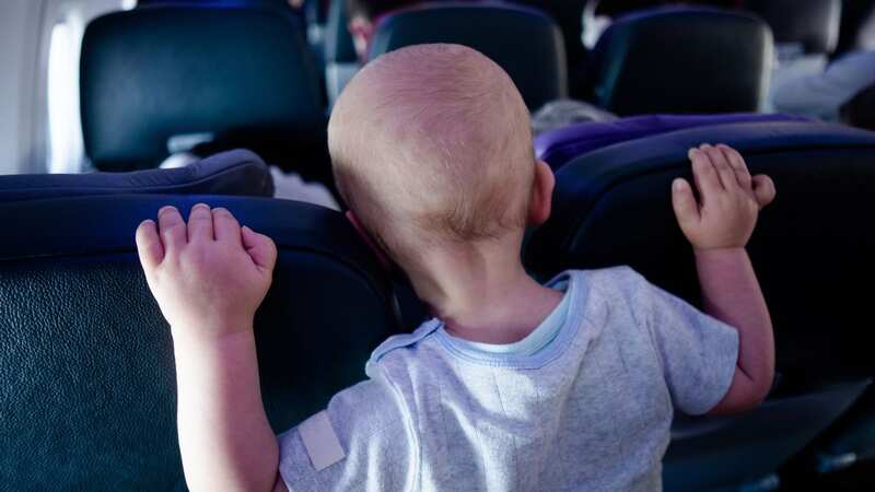 A mum has sparked debate after admitting she flew business class while her partner and baby flew in economy (stock image) (Image: Getty Images)