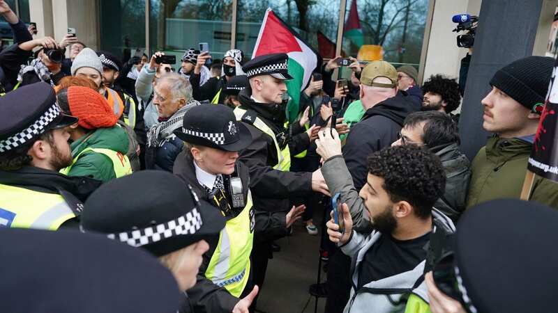 Police officers and pro-Palestine demonstrators in central London today (Image: PA)