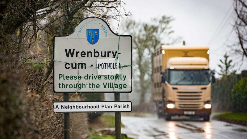 Locals of Wrenbury-cum-Frith, East Cheshire, stand in the potholes to highlight the problem (Image: William Lailey SWNS)