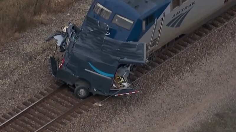 An Amazon delivery driver missed death by inches after an Amtrak train slammed into his truck, splitting it in half but narrowly missing him (Image: ABC 7 CHICAGO)