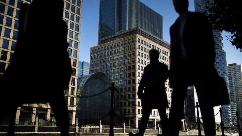 Office workers and commuters walking through Canary Wharf in London during the morning rush hour (Image: PA Wire/PA Images)