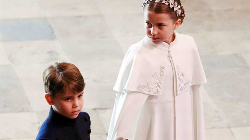 Prince Louis holds hand with big sister Princess Charlotte ahead of the Coronation (Image: Getty Images)