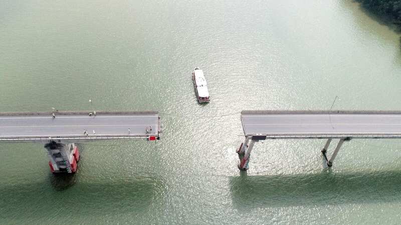 Terrifying moment bridge splits in half plunging cars into river killing five