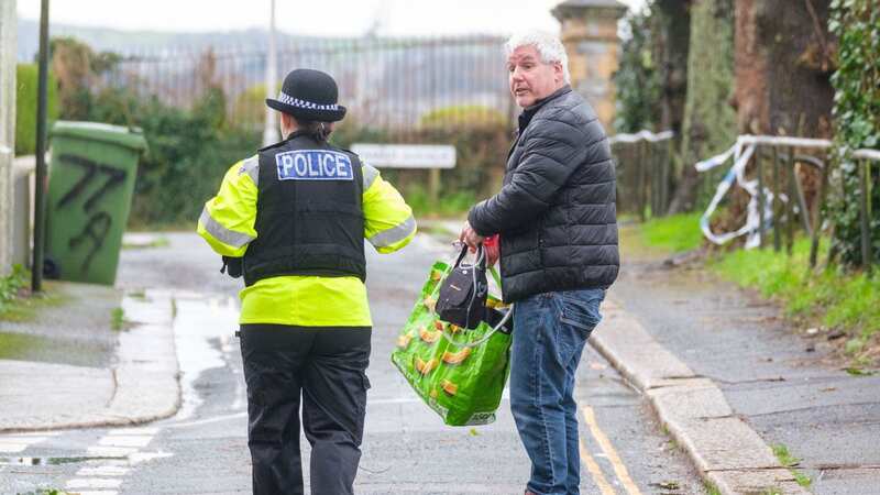 A police officer speaks to a member of the public after homes were evacuated (Image: PA)