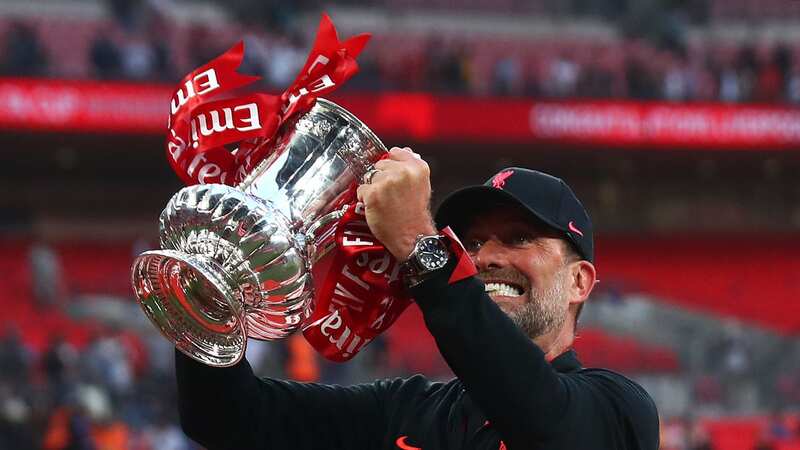 Jurgen Klopp lifts the FA Cup following another penalty win against Chelsea in 2022.