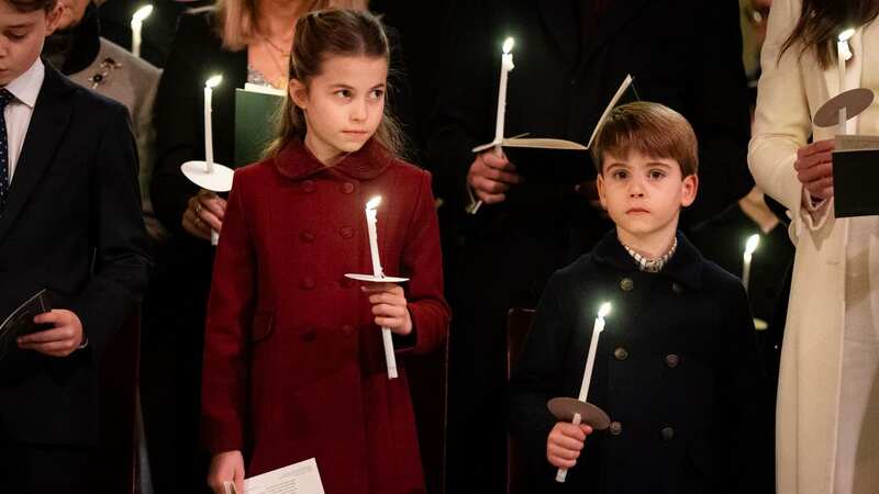 Princess Charlotte and Prince Louis clutching their candles at the annual service (Image: Getty Images)