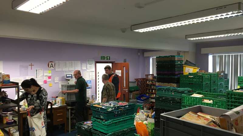 Volunteers sorting through donated food to Blackburn Foodbank (Image: LancsLive)