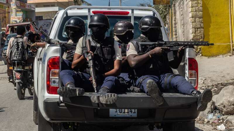Armed police on the back of a truck in Port Au Prince, Haiti (Image: Anadolu Agency via Getty Images)