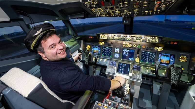 Alberto Paduanelli and his Boeing 737-800 flight simulator that he created in his garage (Image: Tony Kershaw/SWNS)